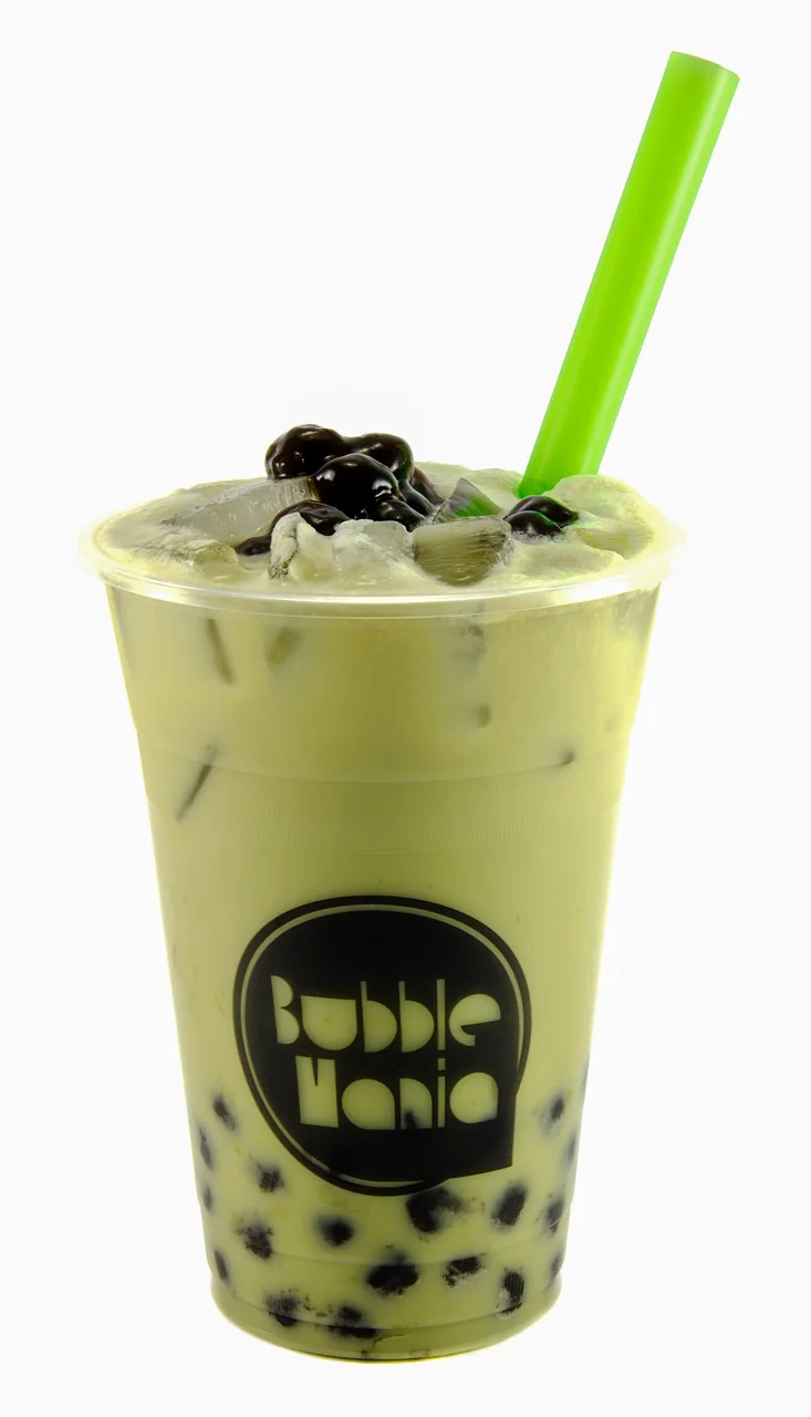Green bubble tea with dark tapioca pearls and a green straw fills a clear cup.