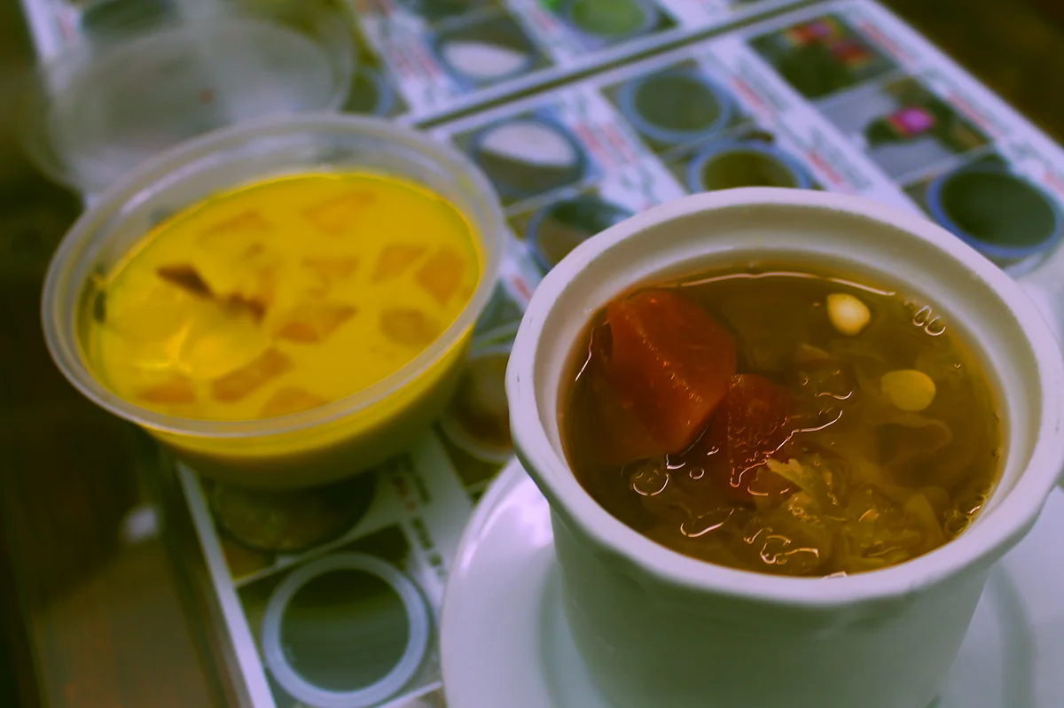Mango pudding and papaya and white fungus sweet soup served in plastic containers.