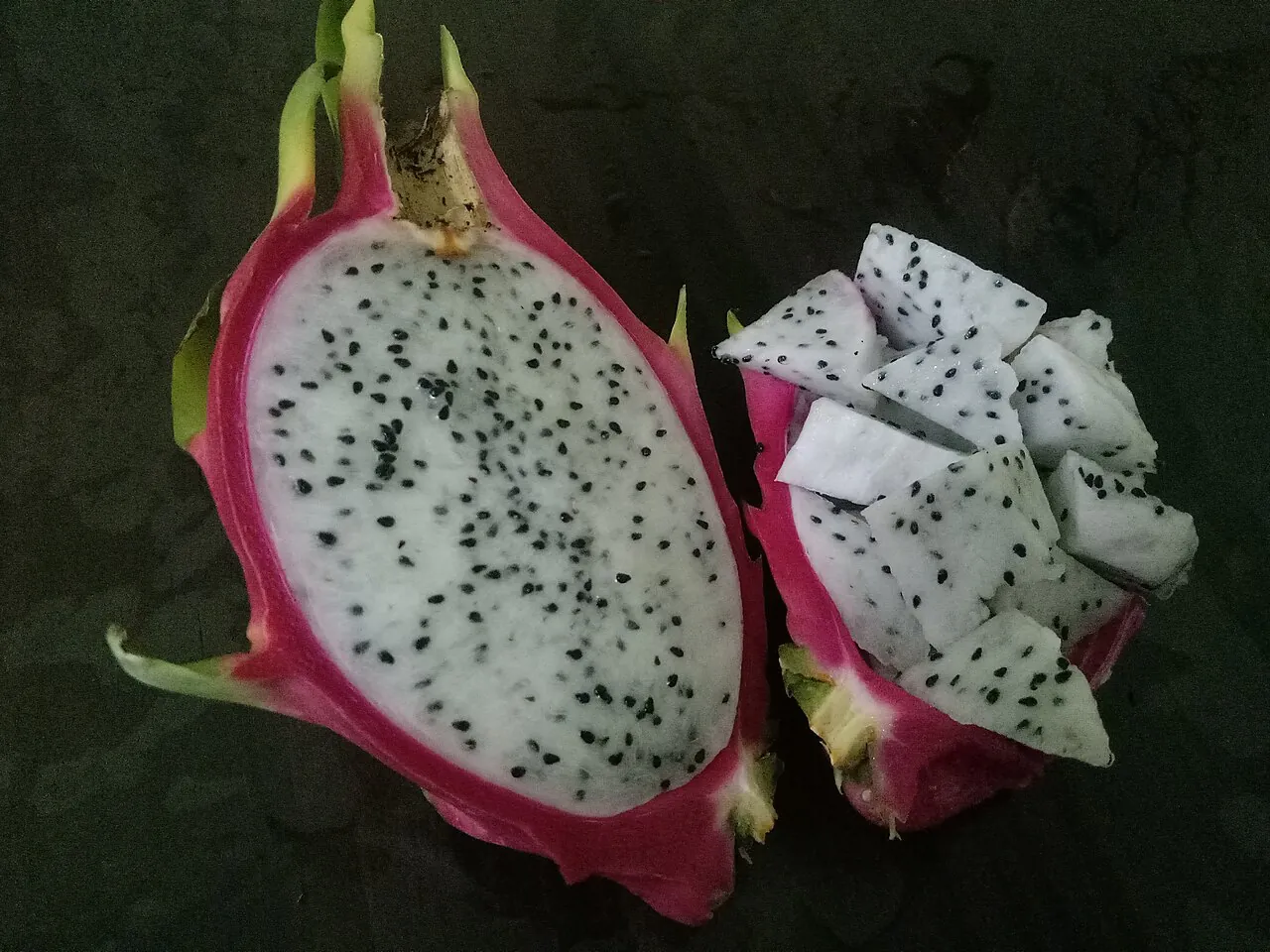 Dragon fruit — A dragon fruit cut in half, white with black seeds.