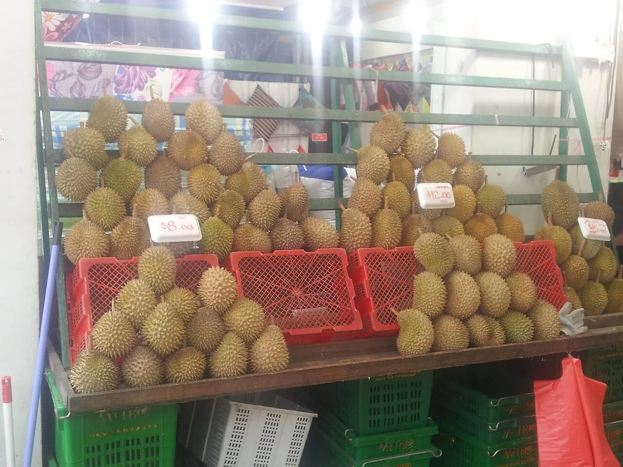 Durian — Whole durians in baskets at a stall, each one covered in spikes.