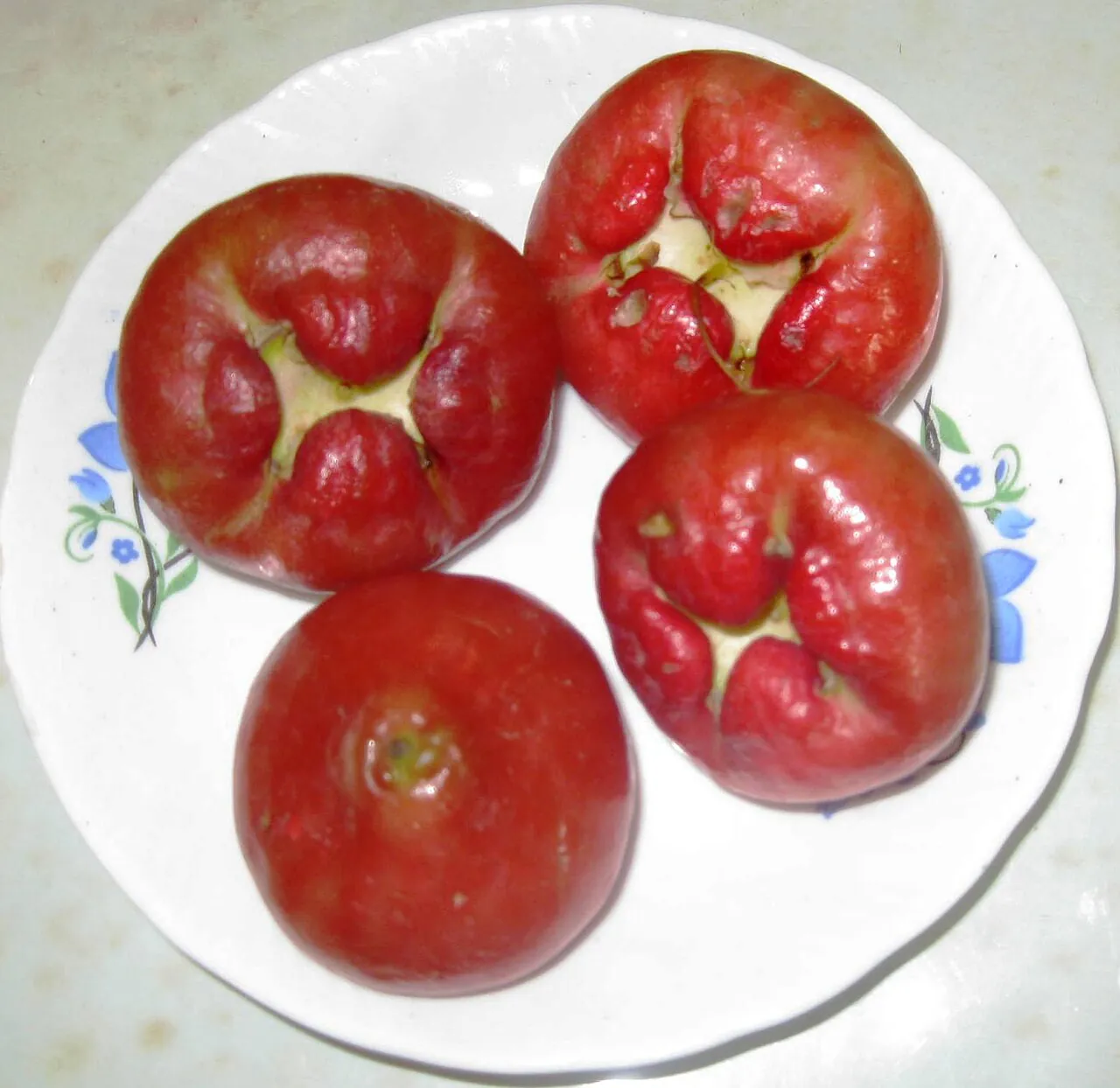 Jambu — Pink jambu in a white bowl with a leaf.