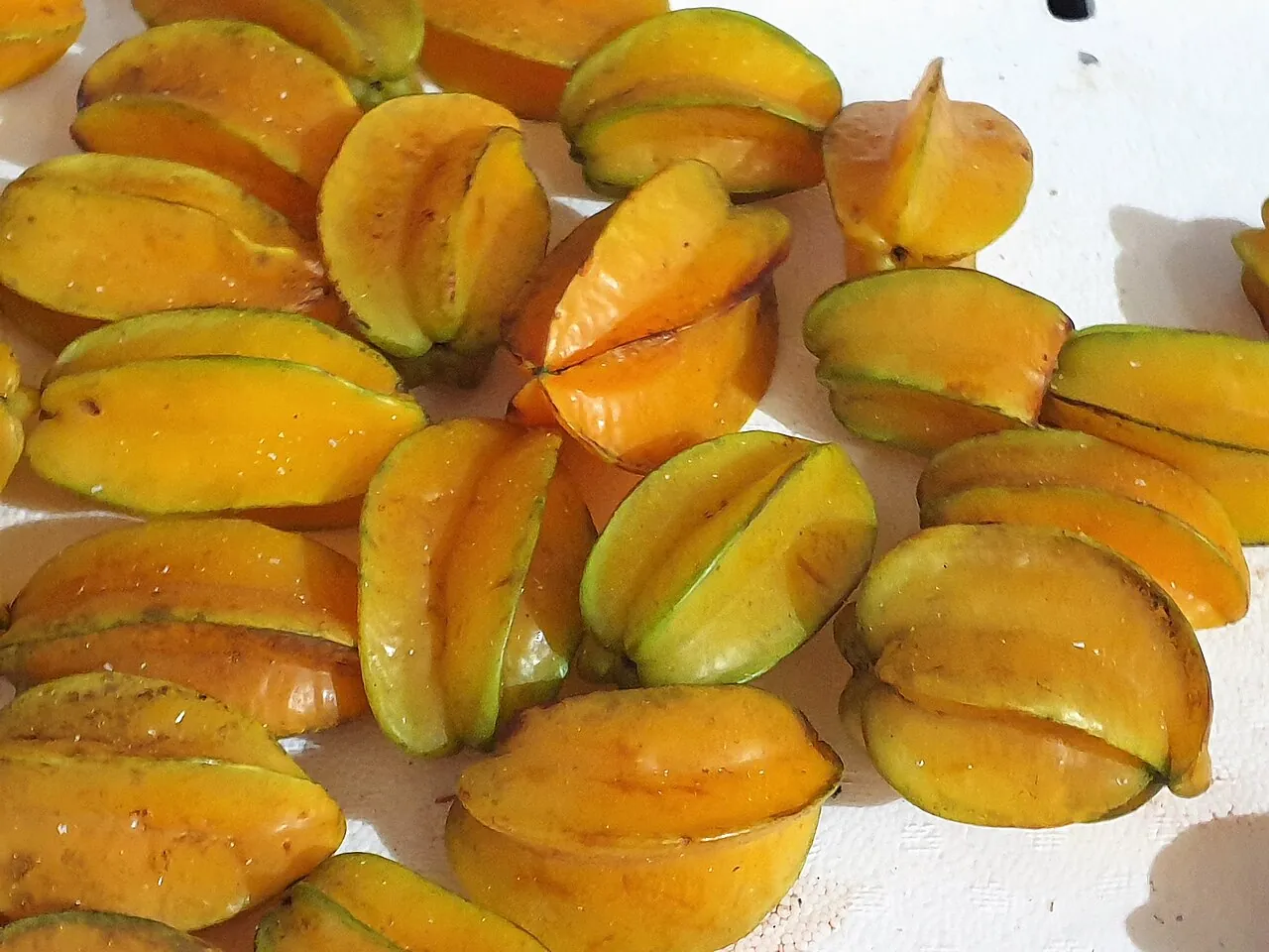 Starfruit — Yellow starfruit piled up, showing their ridges.