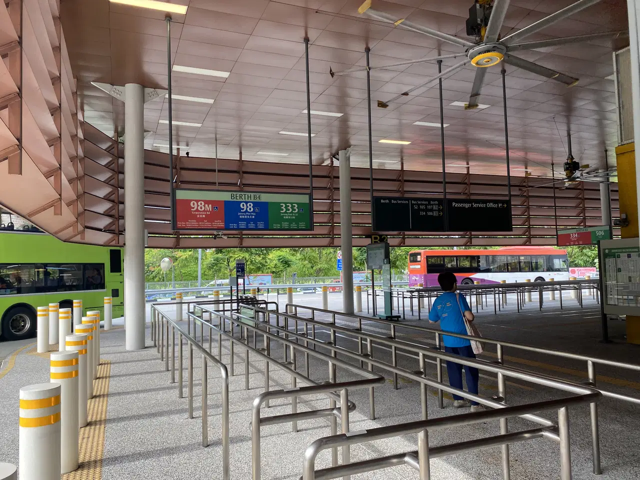 Queue rails and bus bays fill an indoor interchange.