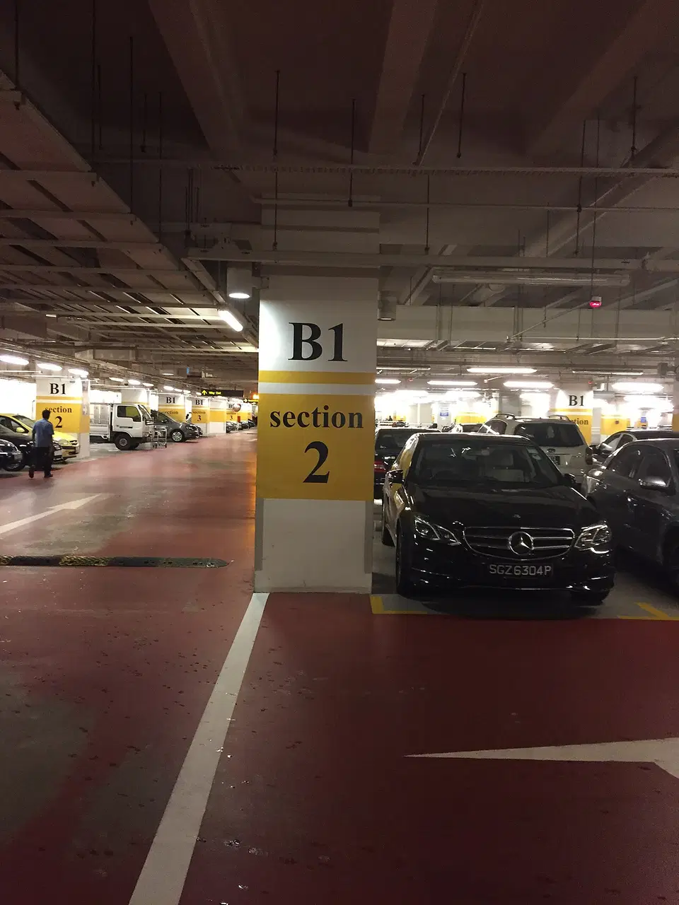Cars are parked under a Changi Airport car-park deck.