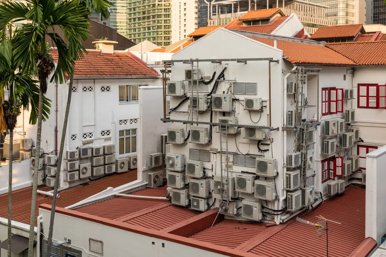 Old shophouses and air-conditioning units fill a Chinatown street.