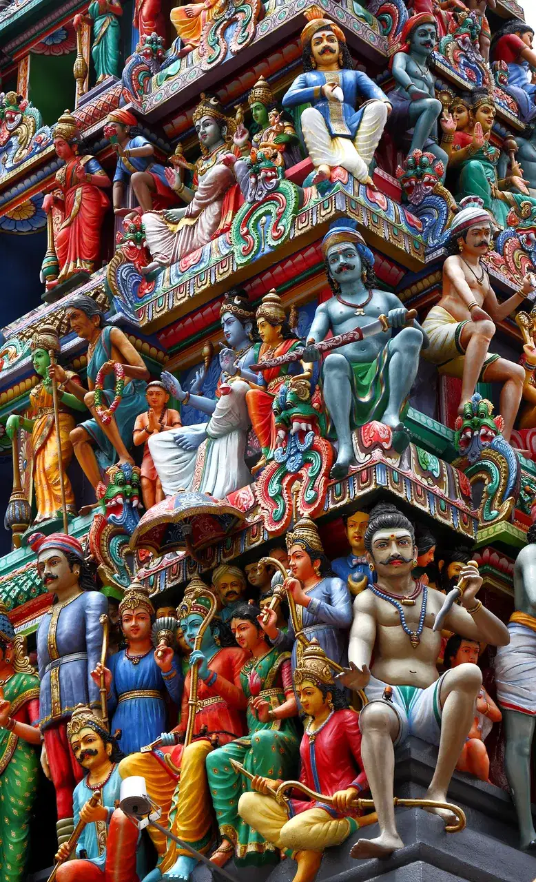 Brightly painted figures cover the tall Hindu temple tower.