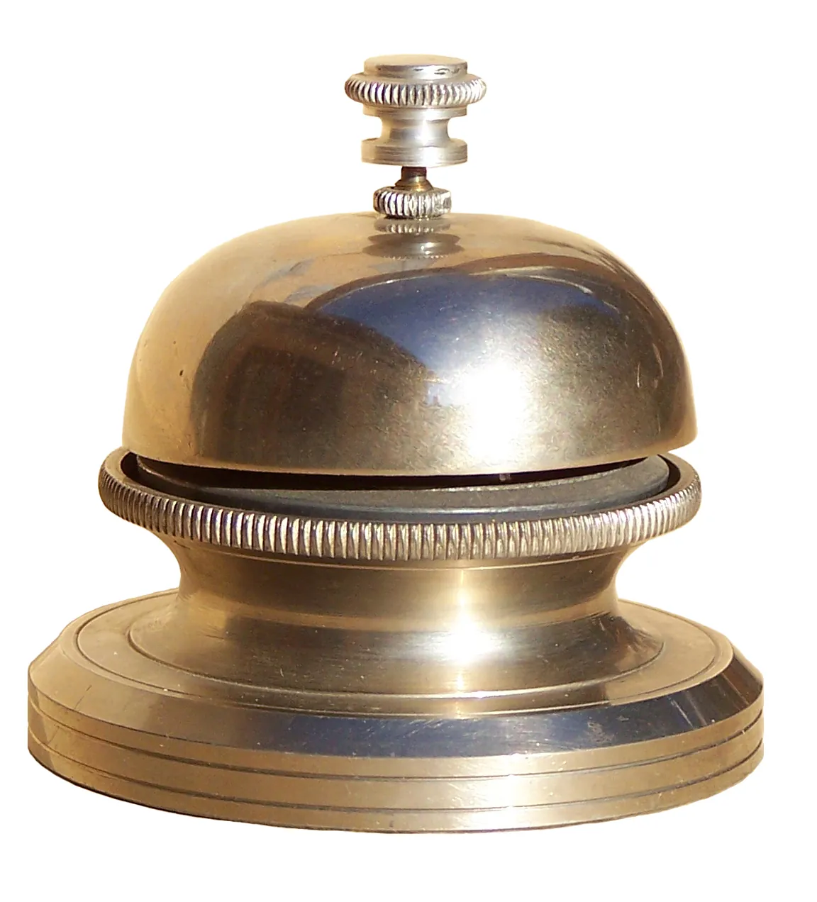 A shiny desk bell sits on a white background.