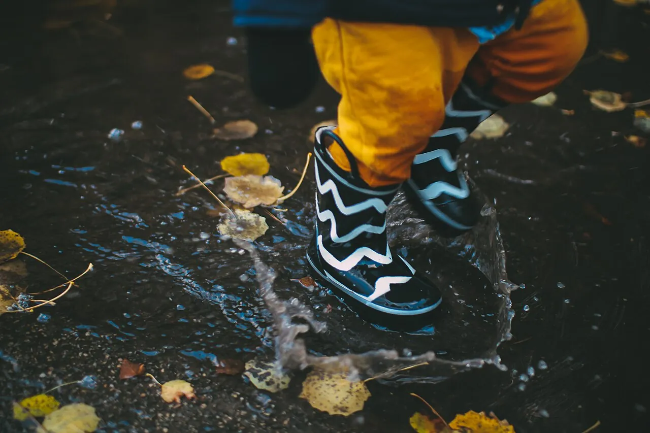 Boots splash in a puddle.