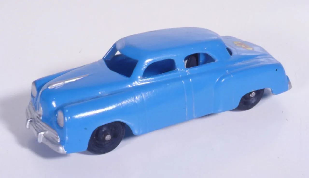 A blue toy car is shown against white.