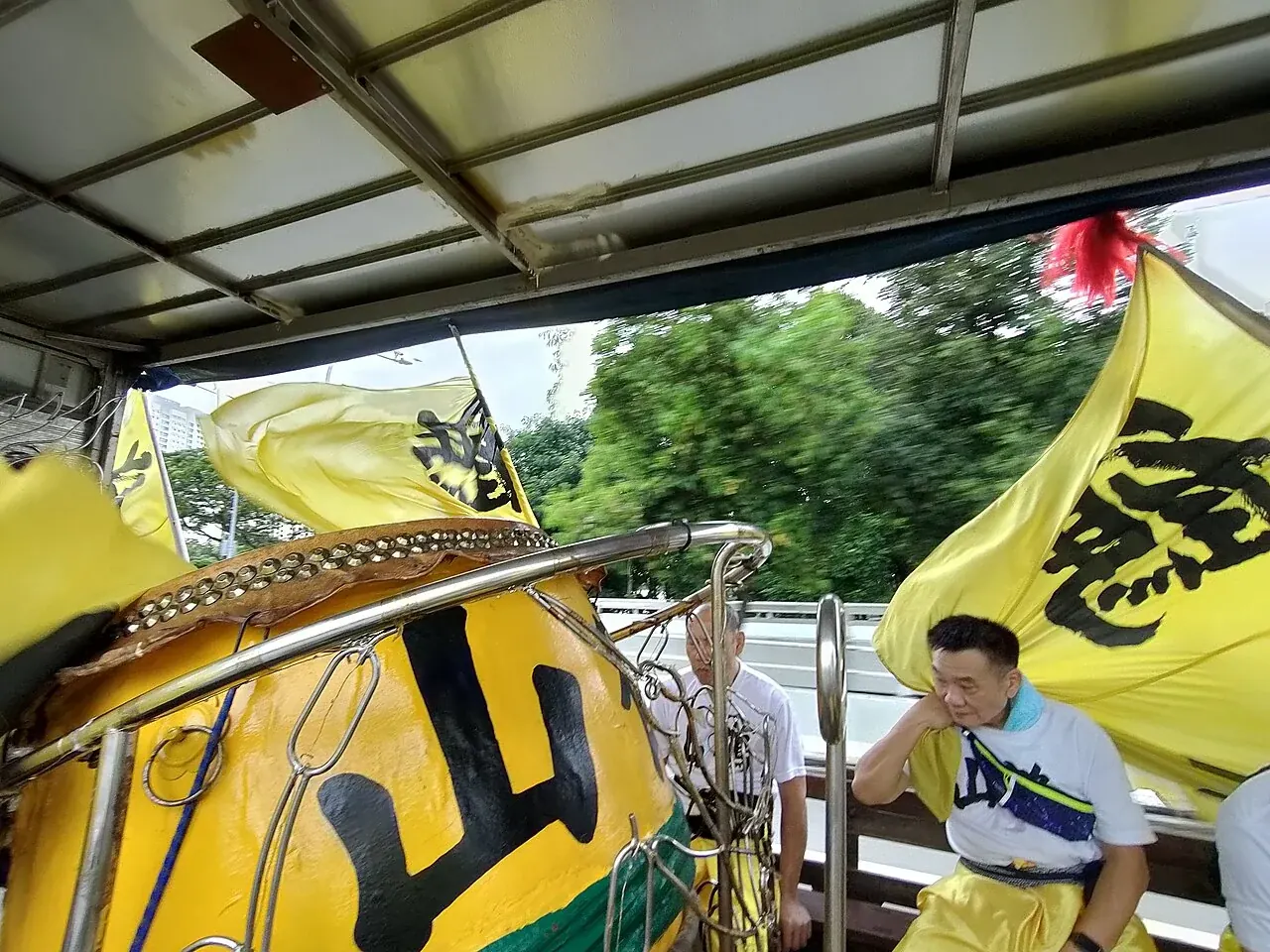 Inside the sheltered, open-sided back of a Singapore lion-dance lorry.