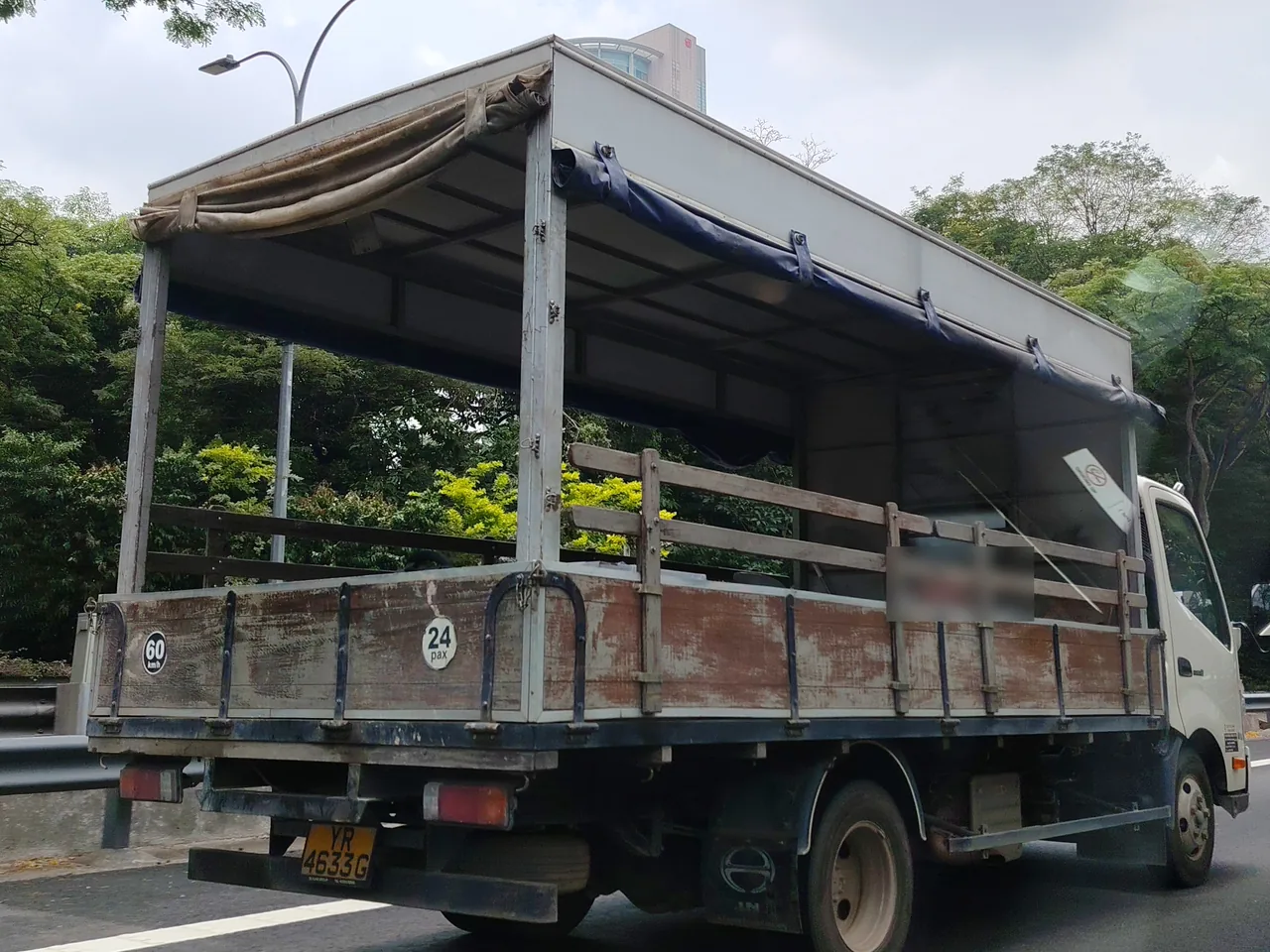 Canopy lorry — a white lorry with a roof over its open wooden-sided back, Photographed in Singapore