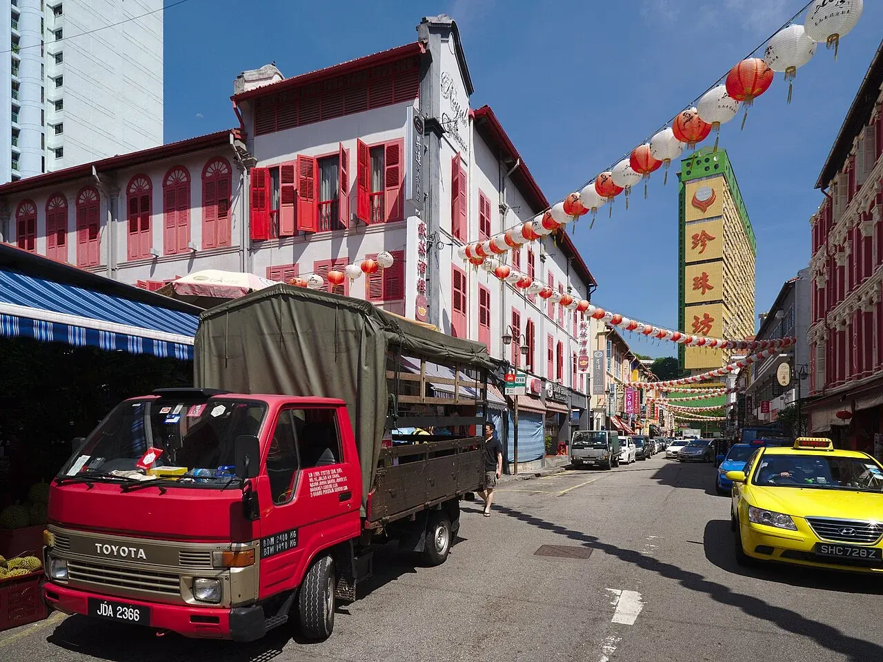 A red canopy lorry delivering durians on Temple Street in Singapore.