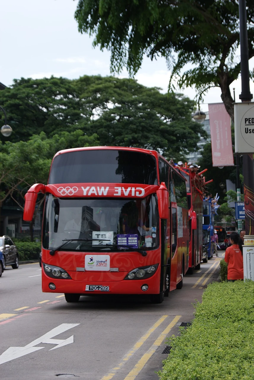 A red coach on Bras Basah Road during the Youth Olympic Games torch relay.