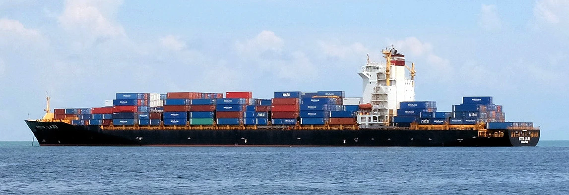 Container ship Kota Laju carrying stacked containers in Singapore.