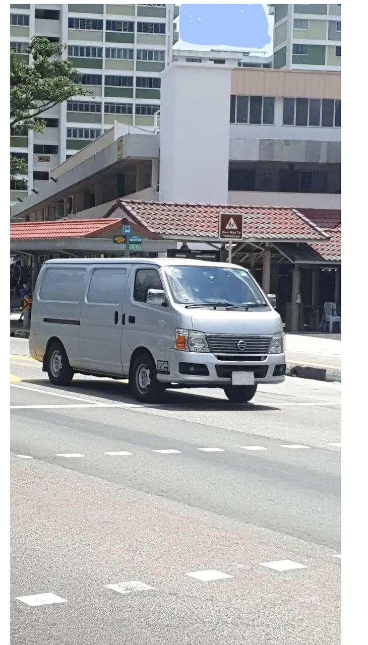 A silver cargo van on a road in Ang Mo Kio.