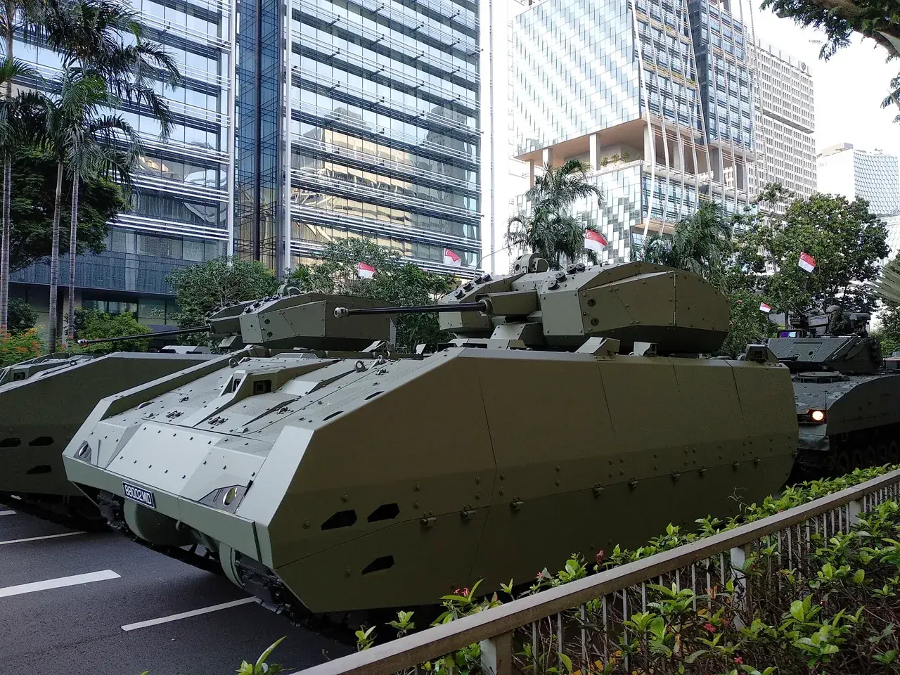 A green tracked army vehicle has a sloping front and a box-shaped top.