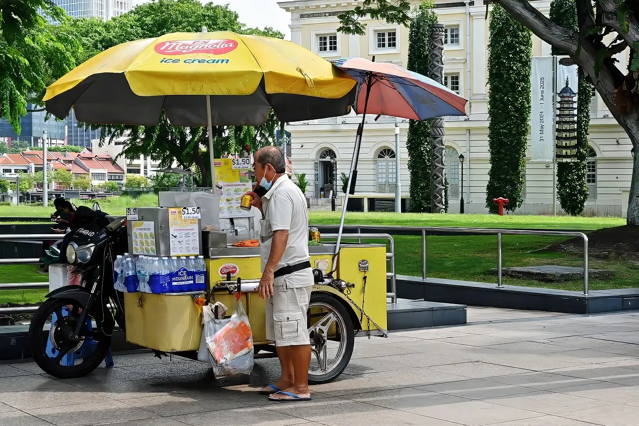 An ice-cream motorcycle cart beside Cavenagh Bridge.