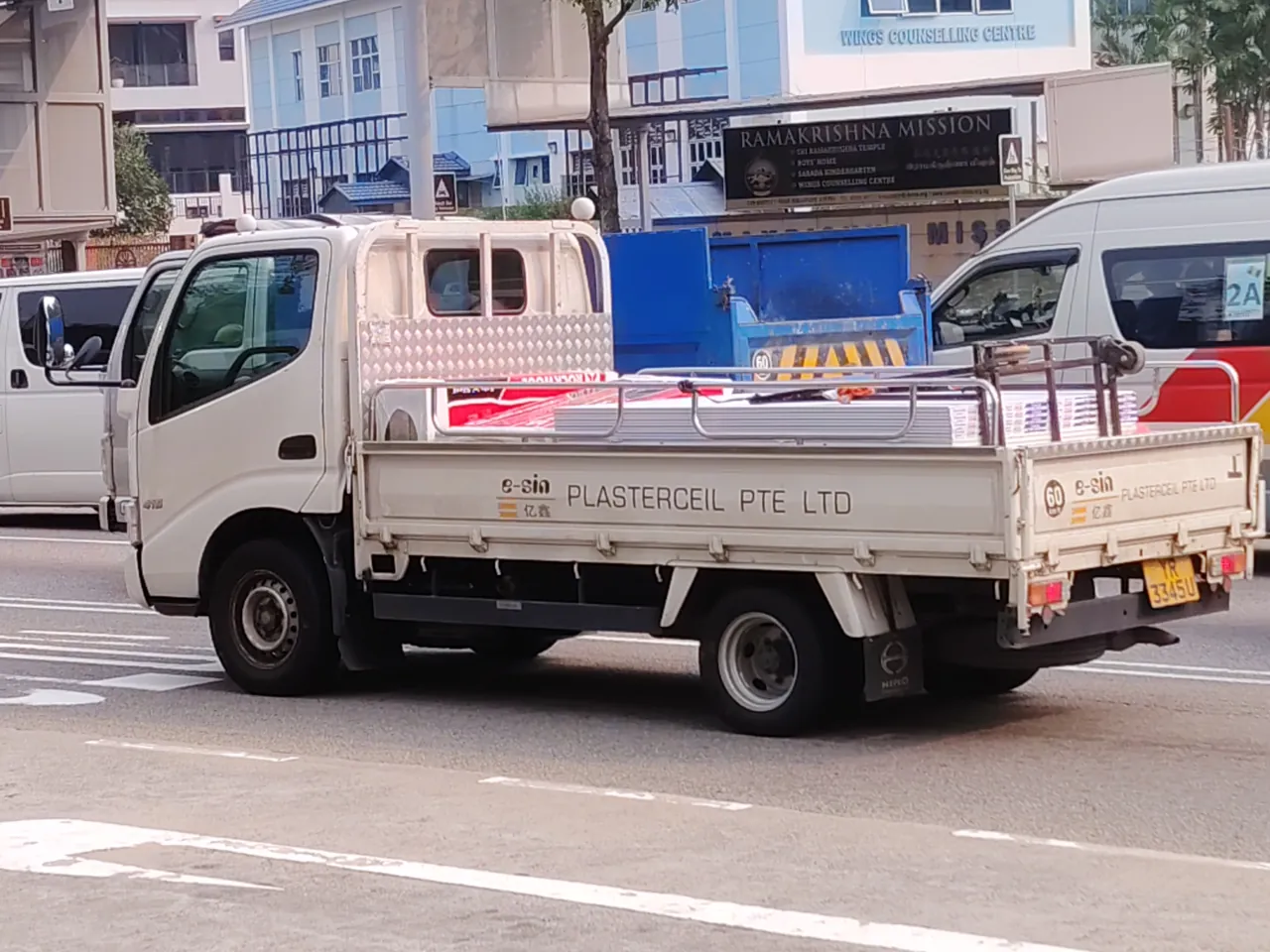 Lorry — a white dropside lorry with its sides folded up, photographed in Singapore.