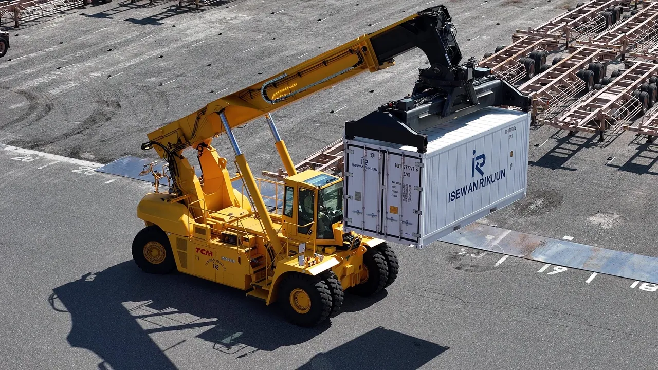 Reach stacker lifting a shipping container.