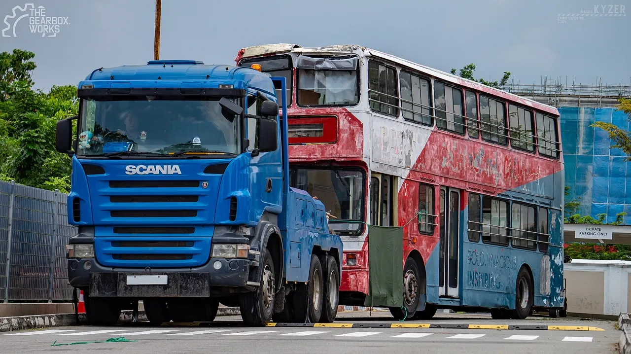 Recovery truck towing a damaged bus in Singapore.