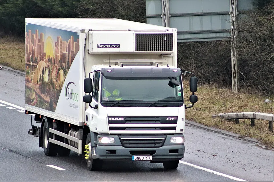 A white refrigerated truck has a cooling unit above its windscreen.