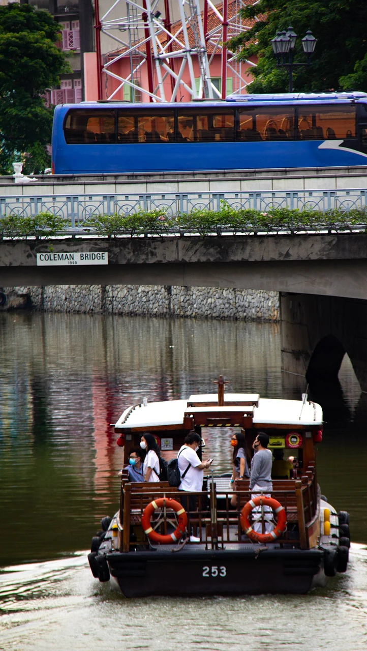 A Singapore River cruise boat carrying passengers.