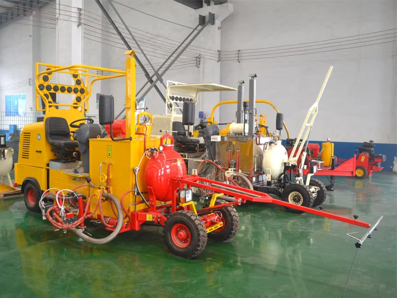 A road-marking machine has tanks, pipes and a long guide arm.