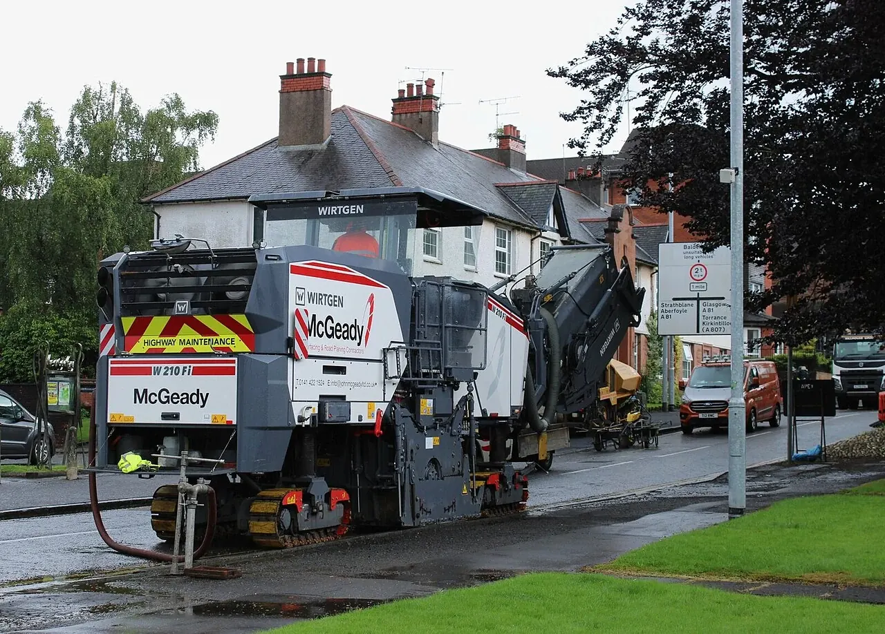 A road milling machine using its conveyor during street resurfacing.
