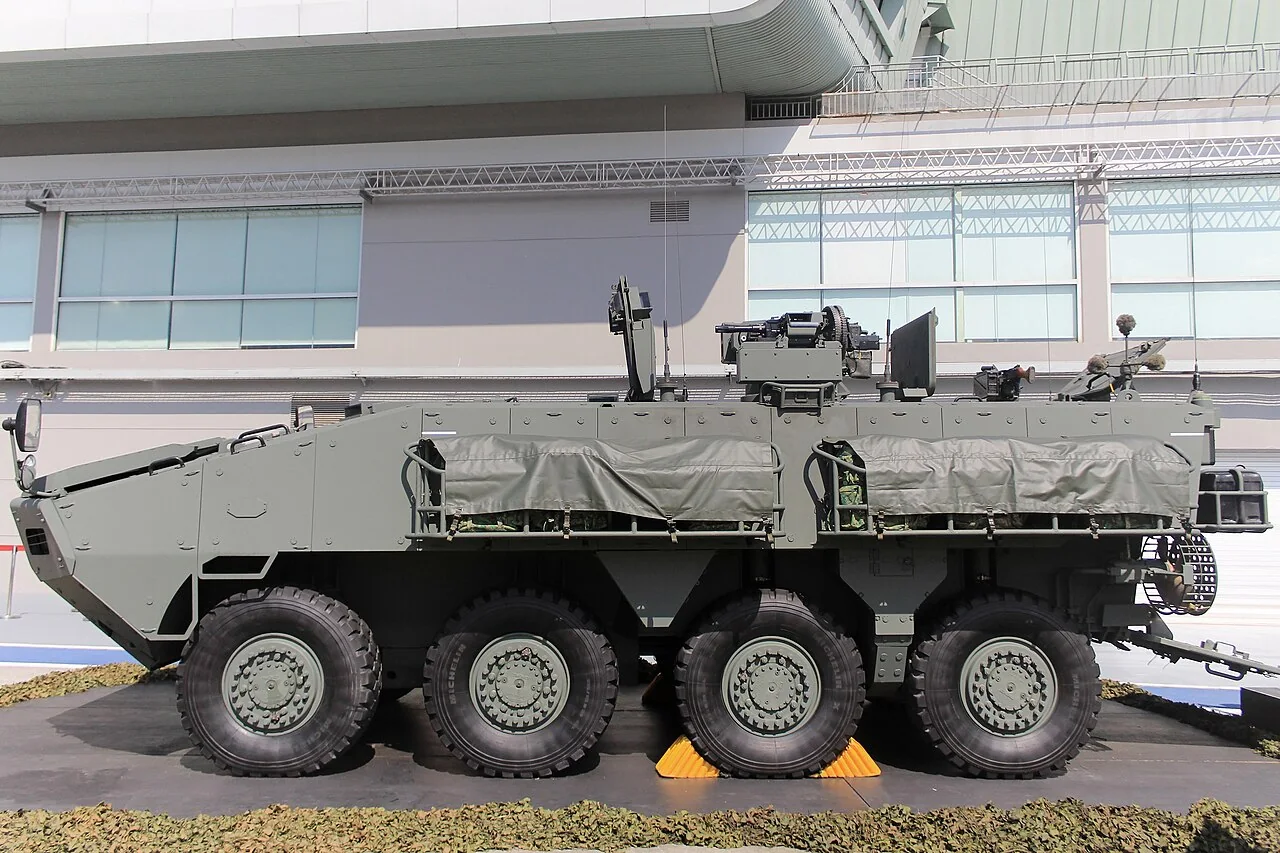 Four large wheels line the visible side of a green Terrex carrier.