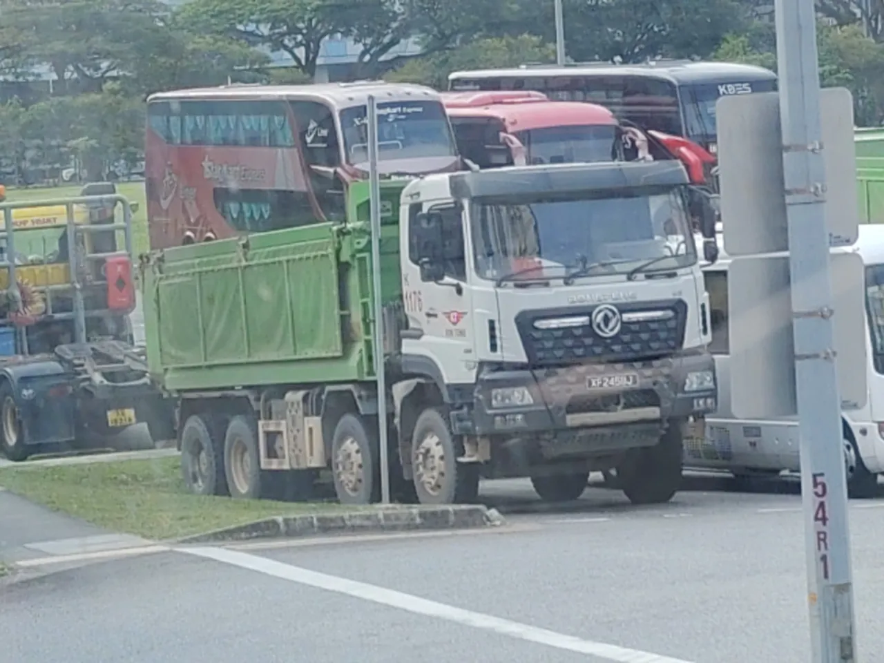 Tipper truck — a big tipper truck with a green tipping body, Photographed in Singapore